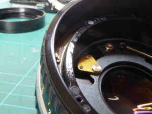Nikon E Series Lens Repair - As received showing oil contamination