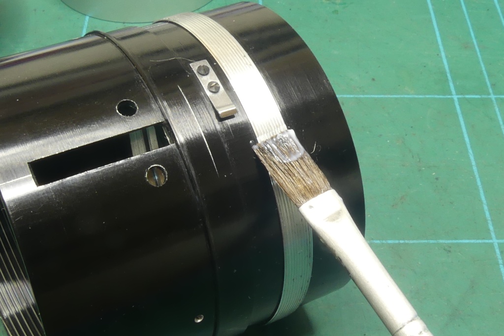 Lightly grease the aperture ring threads on the lens body